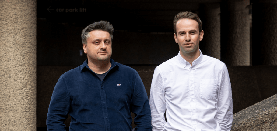 Vlad Gulu and Tom Garnett, founders of Refute posing for a photo outside in an urban setting.